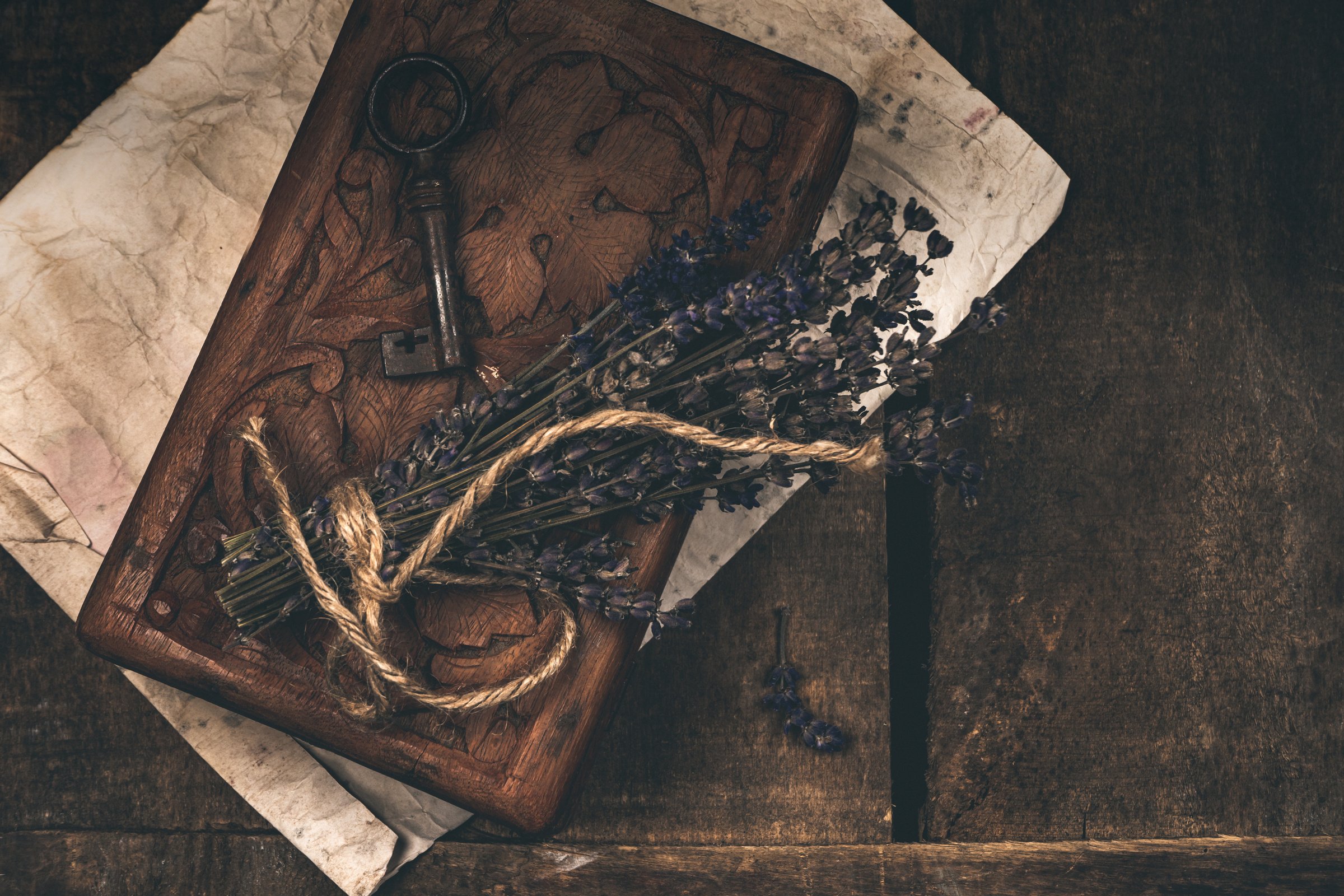 Old Key and Dried Flowers over Wood